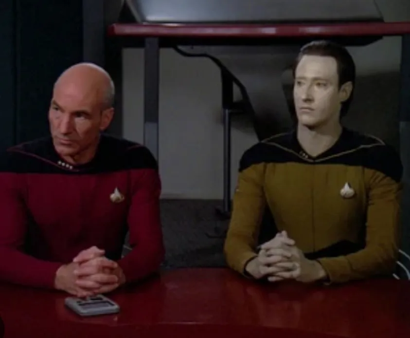 Picard and Data seated side by side at the hearing table in "The Measure of a Man".