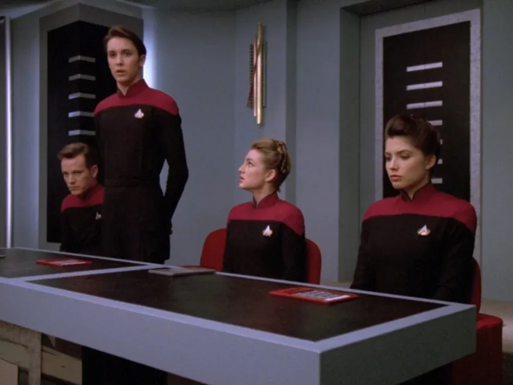 Wesley stands to give testimony while the rest of Nova Squadron sits at the inquiry table in "The First Duty".