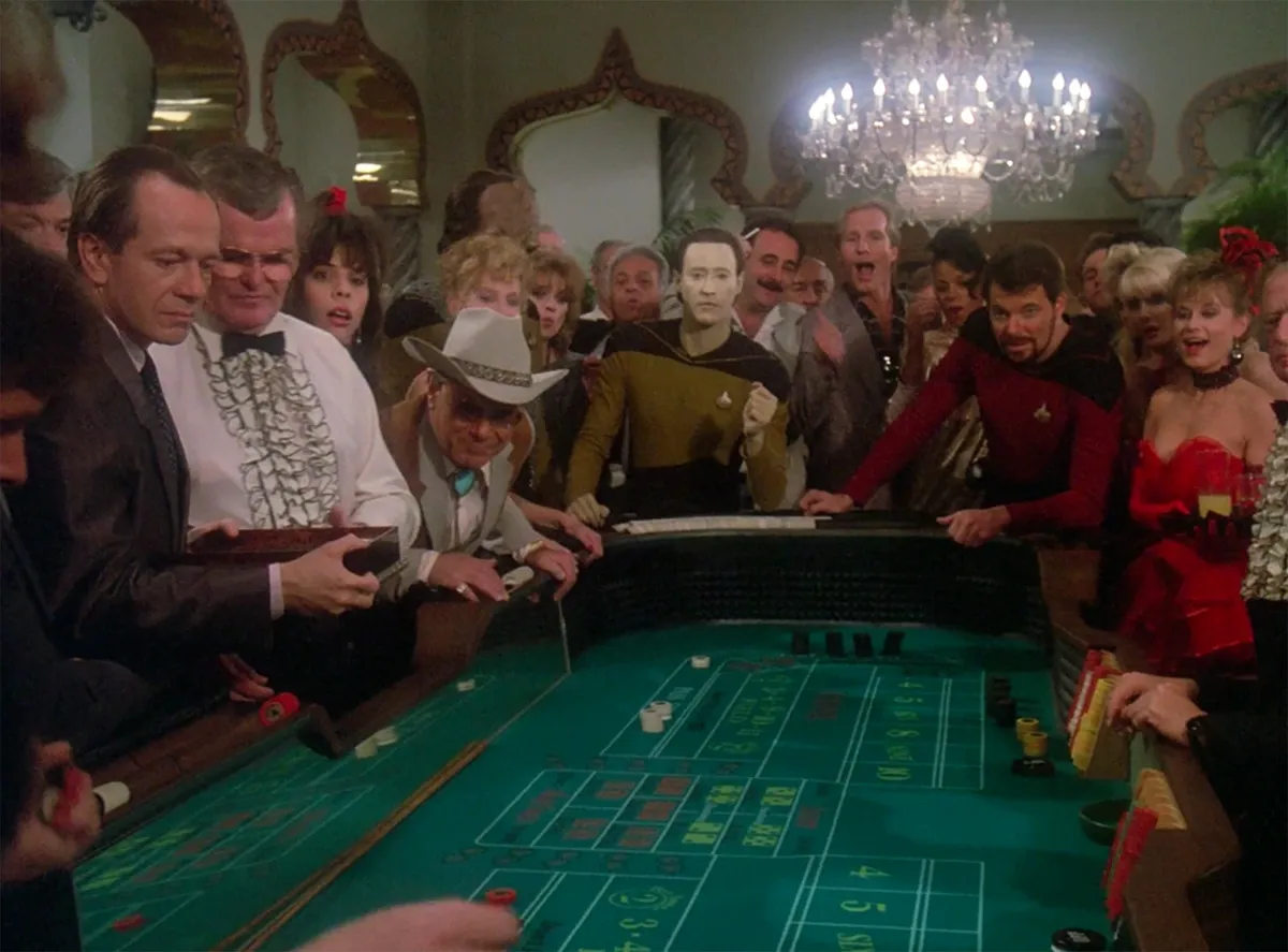 Data and Riker at a crowded craps table in the Royale casino, in Star Trek: The Next Generation's "The Royale".